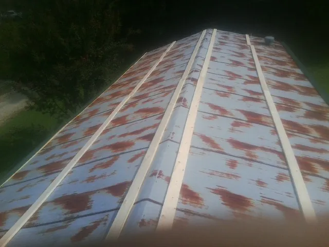 Rusted metal roof panels with new wood purlins before replacement — Storm Damage Roof Repair in Oldwick by Roofing Brothers