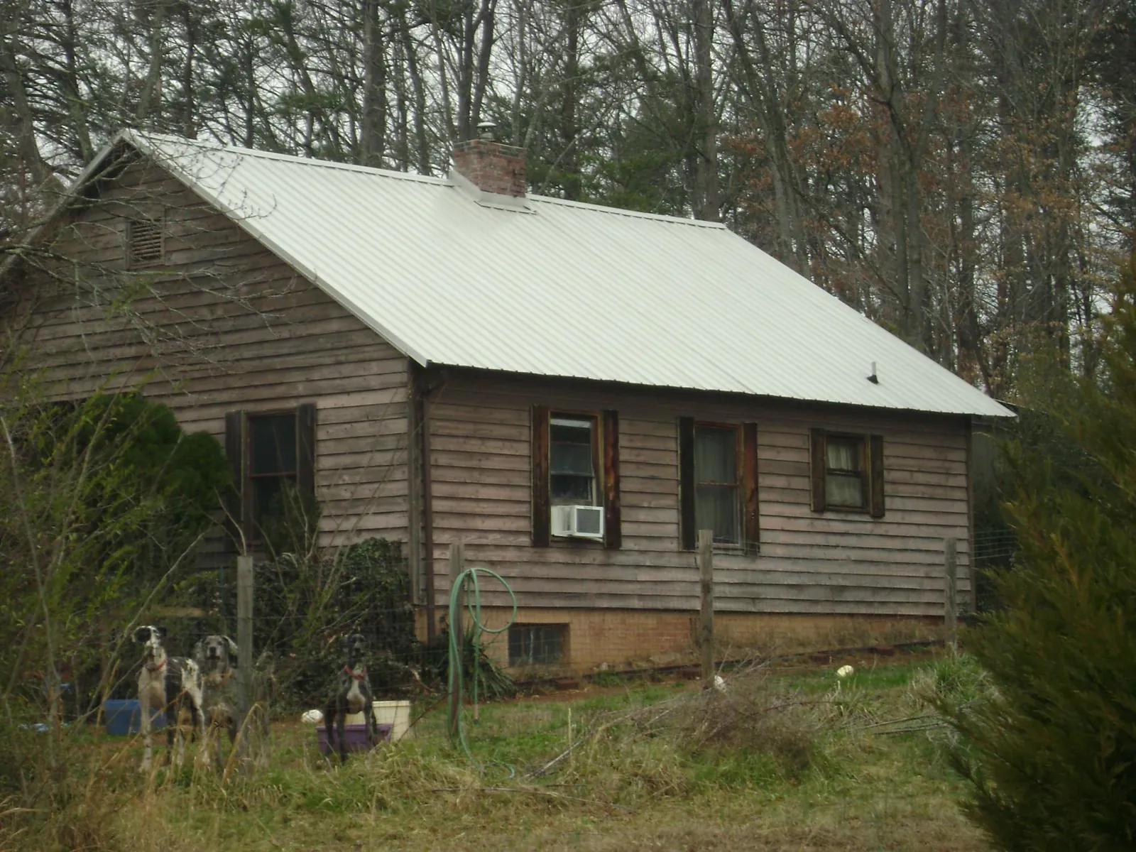 White metal roof on an old wood sided farmhouse, from a Metal Roof Installation job in Oldwick